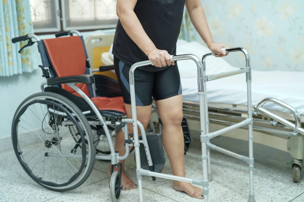 Asian woman patient walk with walker